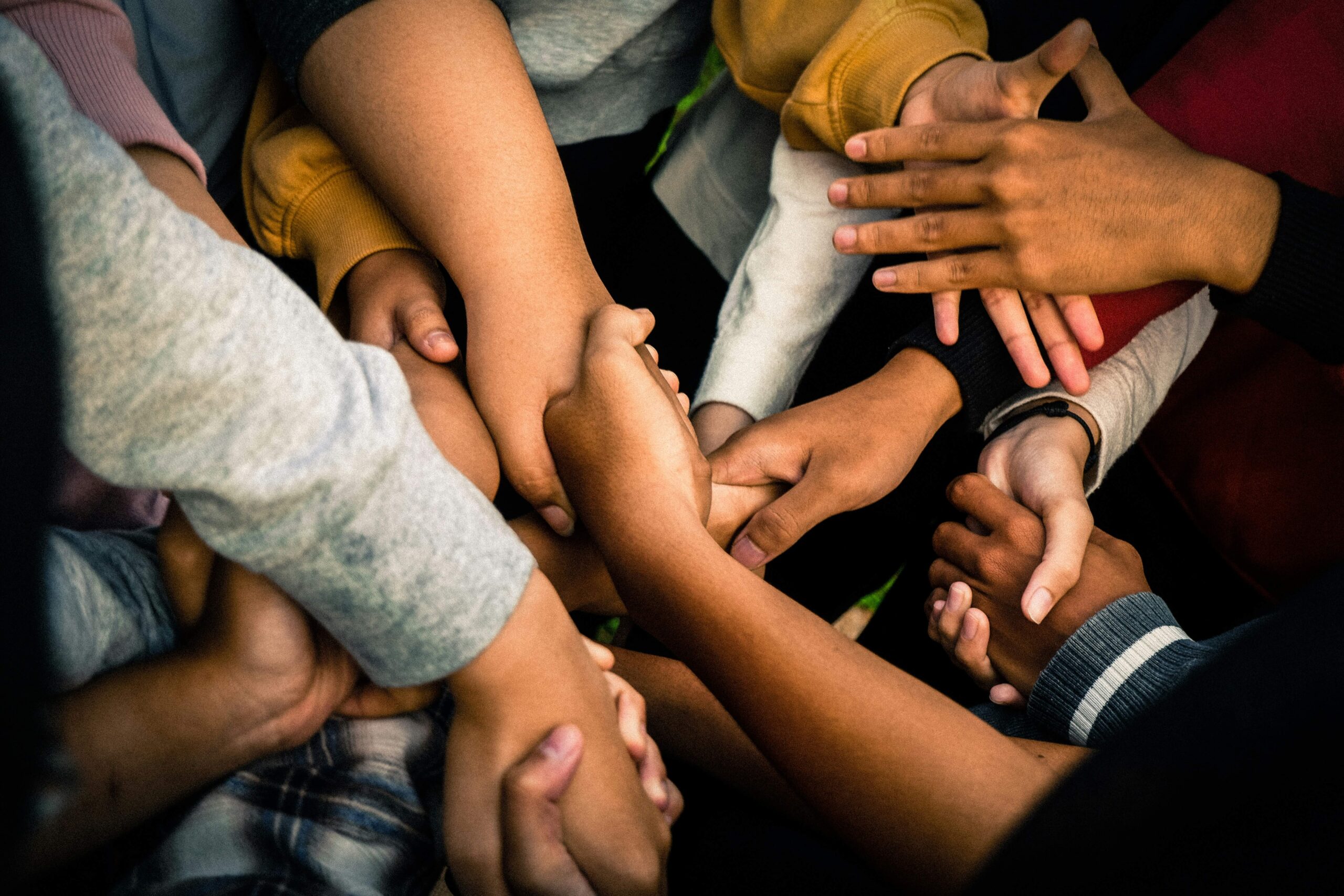 adults and children all holding hands