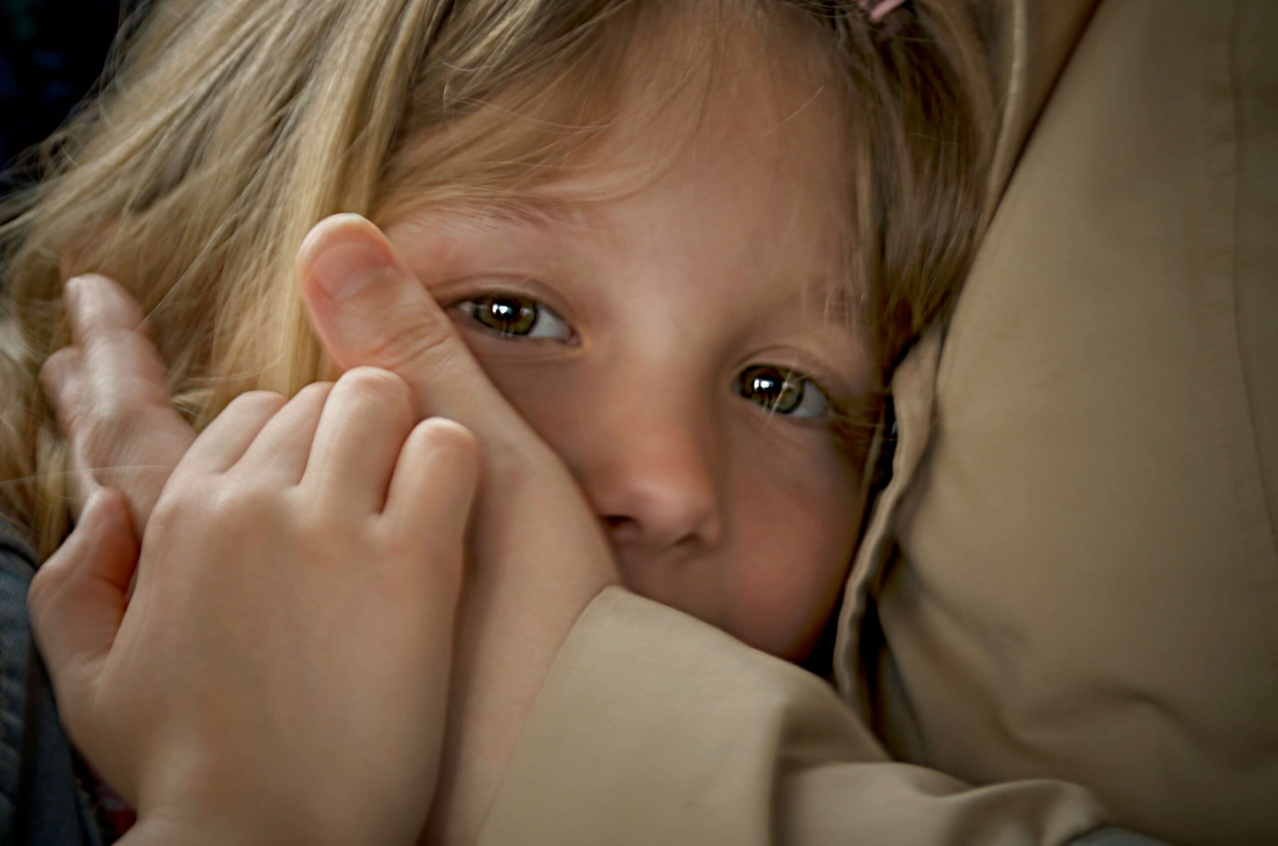 child hugging and adult - face being held by adult hands